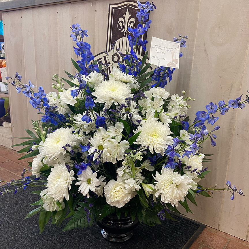 White and purple sympathy floral arrangement.