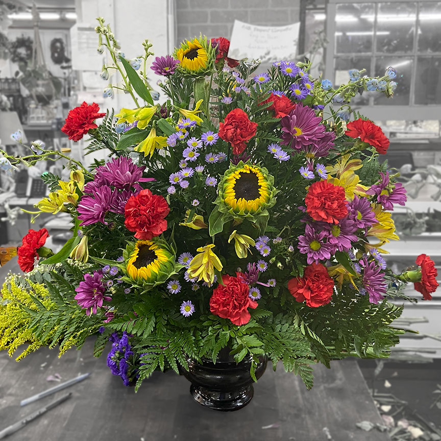 Colorful sympathy floral arrangement.