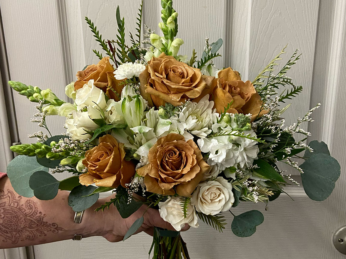 Wedding bouquet - white and tan flowers.