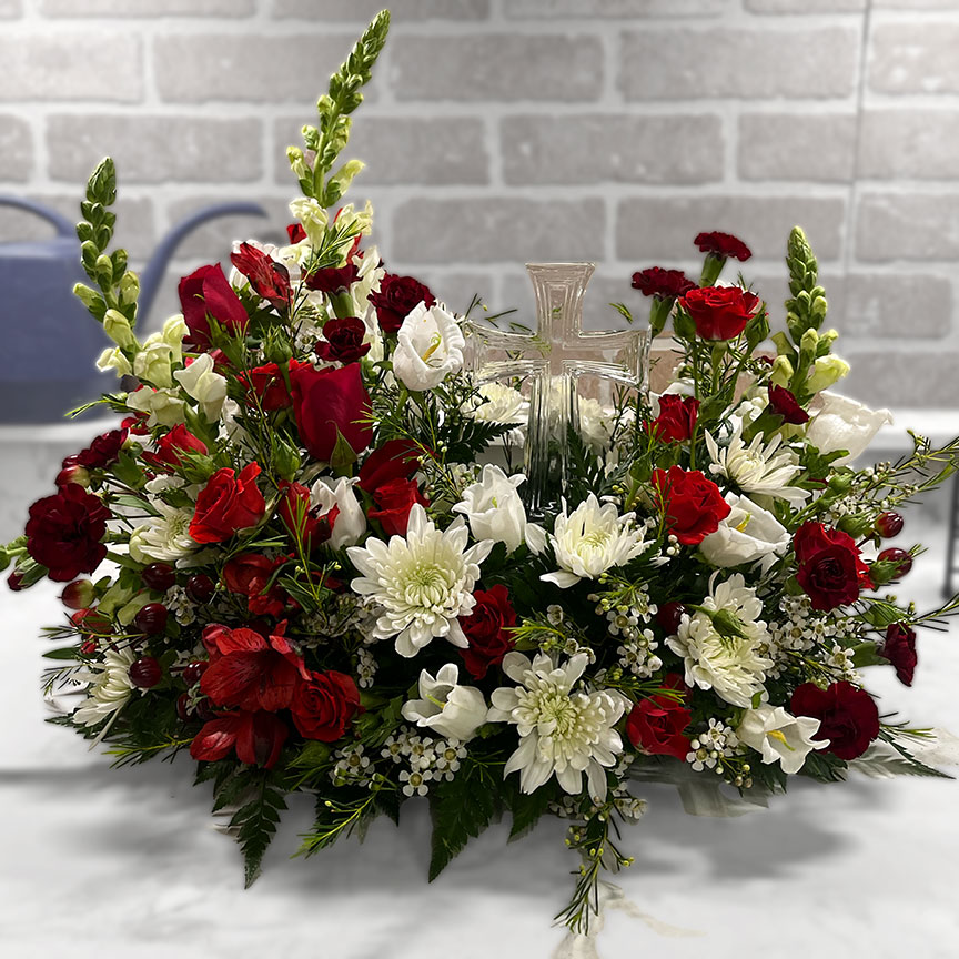 Urn flower piece with clear cross.