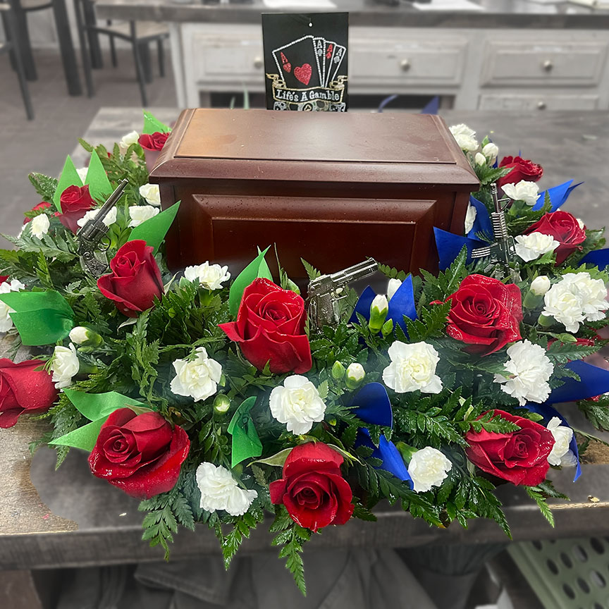 Urn flower piece with red, white, and blue flowers urn.