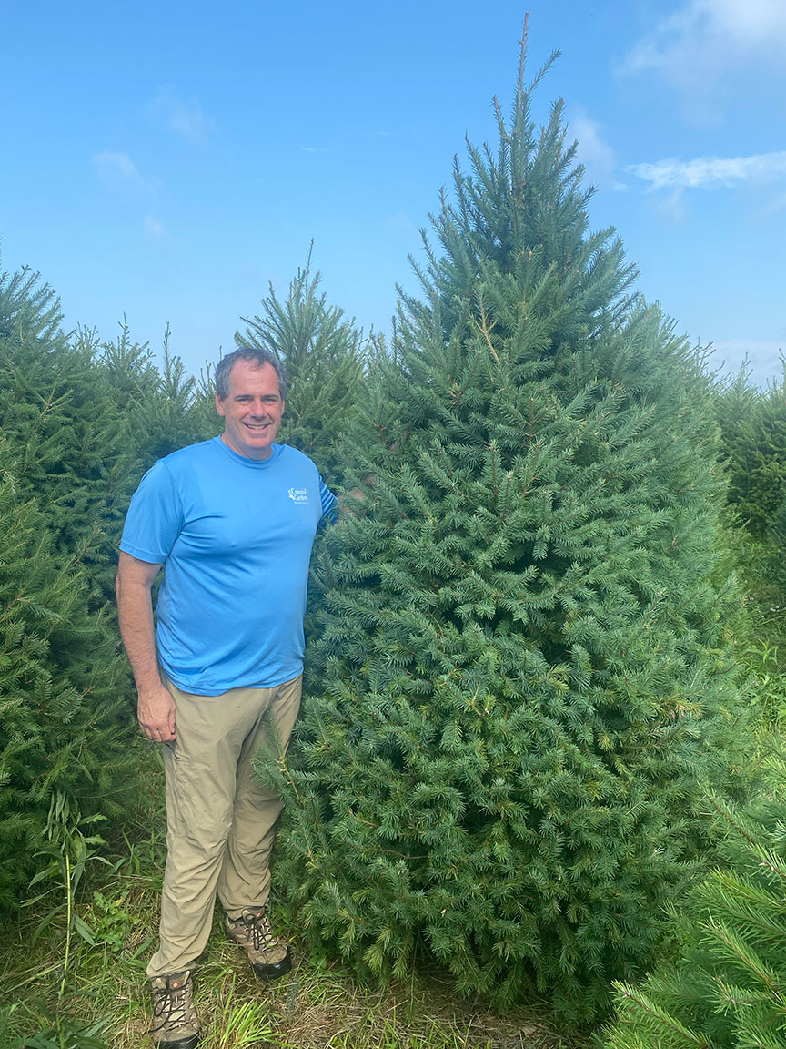 Eric at a local family farm with a Christmas tree.